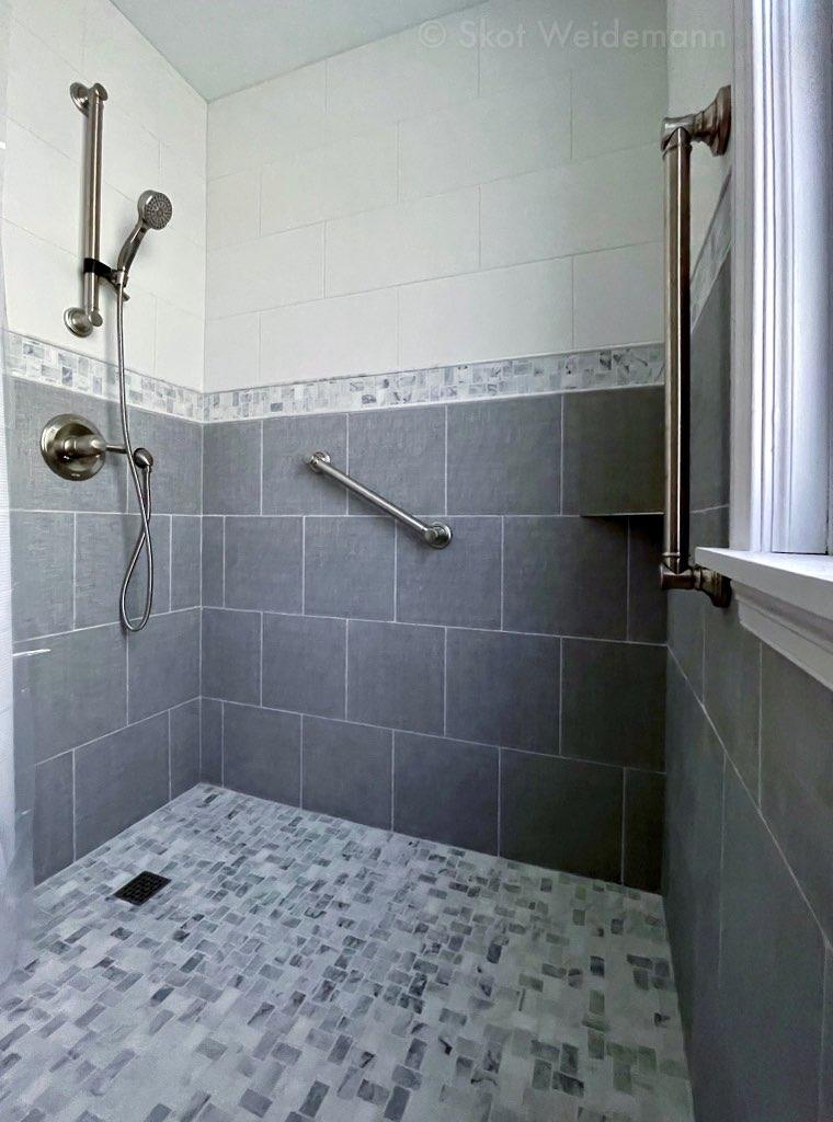 Walk-in shower with beautiful tile work.